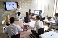 Instructor teaching presentation skills to students using AI-powered tools like hiCreo.ai in a classroom setting