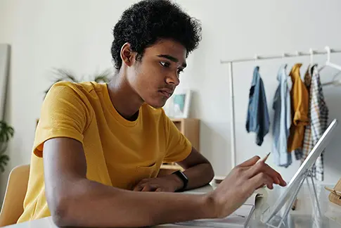 Focused student using an AI presentation maker on a tablet to create presentations with AI and professional presentation templates.