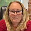 Profile photo of Chris Garvey, a woman with blond hair, glasses, and a red t-shirt.