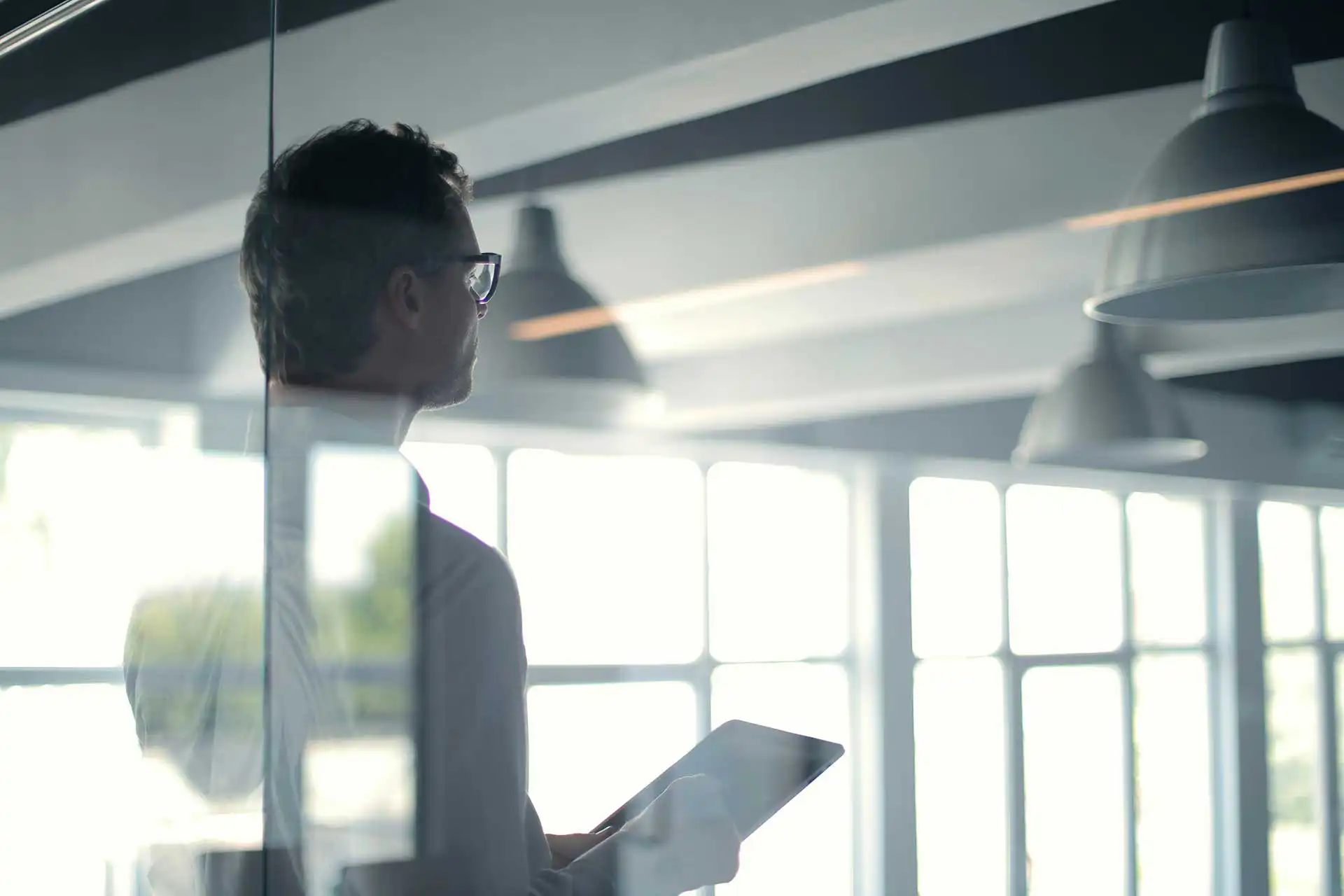 Presenter using hiCreo AI for a dynamic presentation, holding a tablet to navigate slides about brand visual identity.